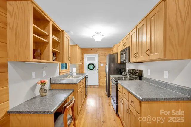 a kitchen with a stove a sink a refrigerator and wooden cabinets