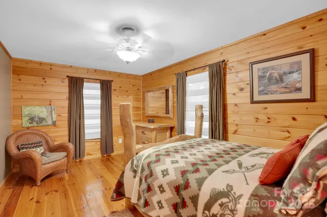 a spacious bedroom with a large bed and a chandelier