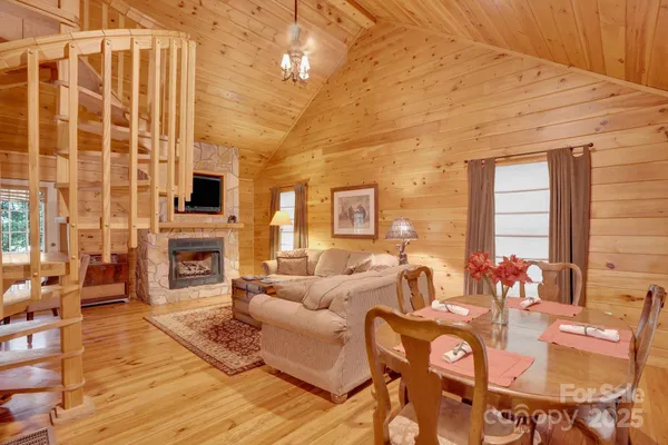 a living room with furniture a fireplace and a floor to ceiling window