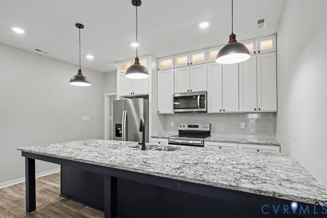 302 Cedar Grove Road Farnham, VA 22460 - Photo 11 of 23 a kitchen with stainless steel appliances granite countertop a sink a refrigerator and microwave