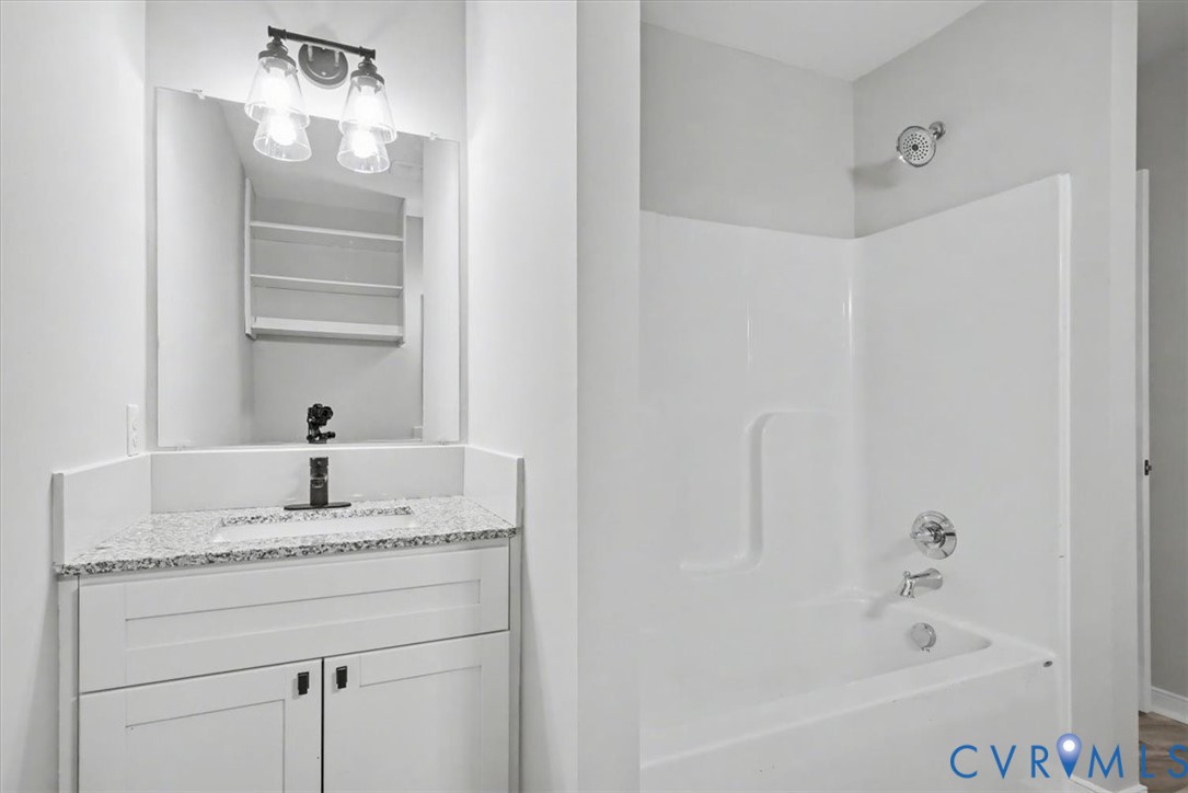 302 Cedar Grove Road Farnham, VA 22460 - Photo 18 of 23 a bathroom with a granite countertop sink and a mirror