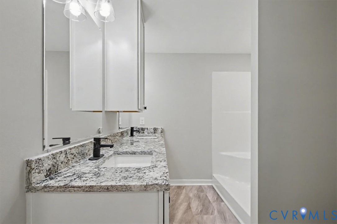 302 Cedar Grove Road Farnham, VA 22460 - Photo 5 of 23 a bathroom with a granite countertop sink and a mirror