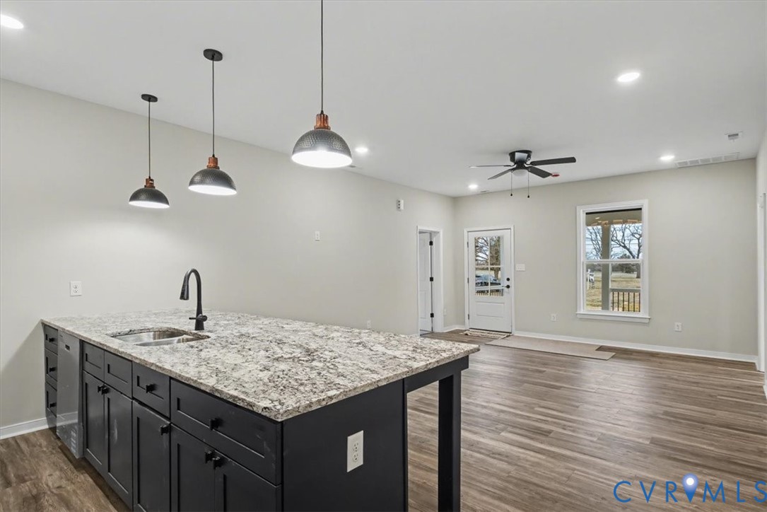 302 Cedar Grove Road Farnham, VA 22460 - Photo 10 of 23 a kitchen with a sink chandelier and wooden floor
