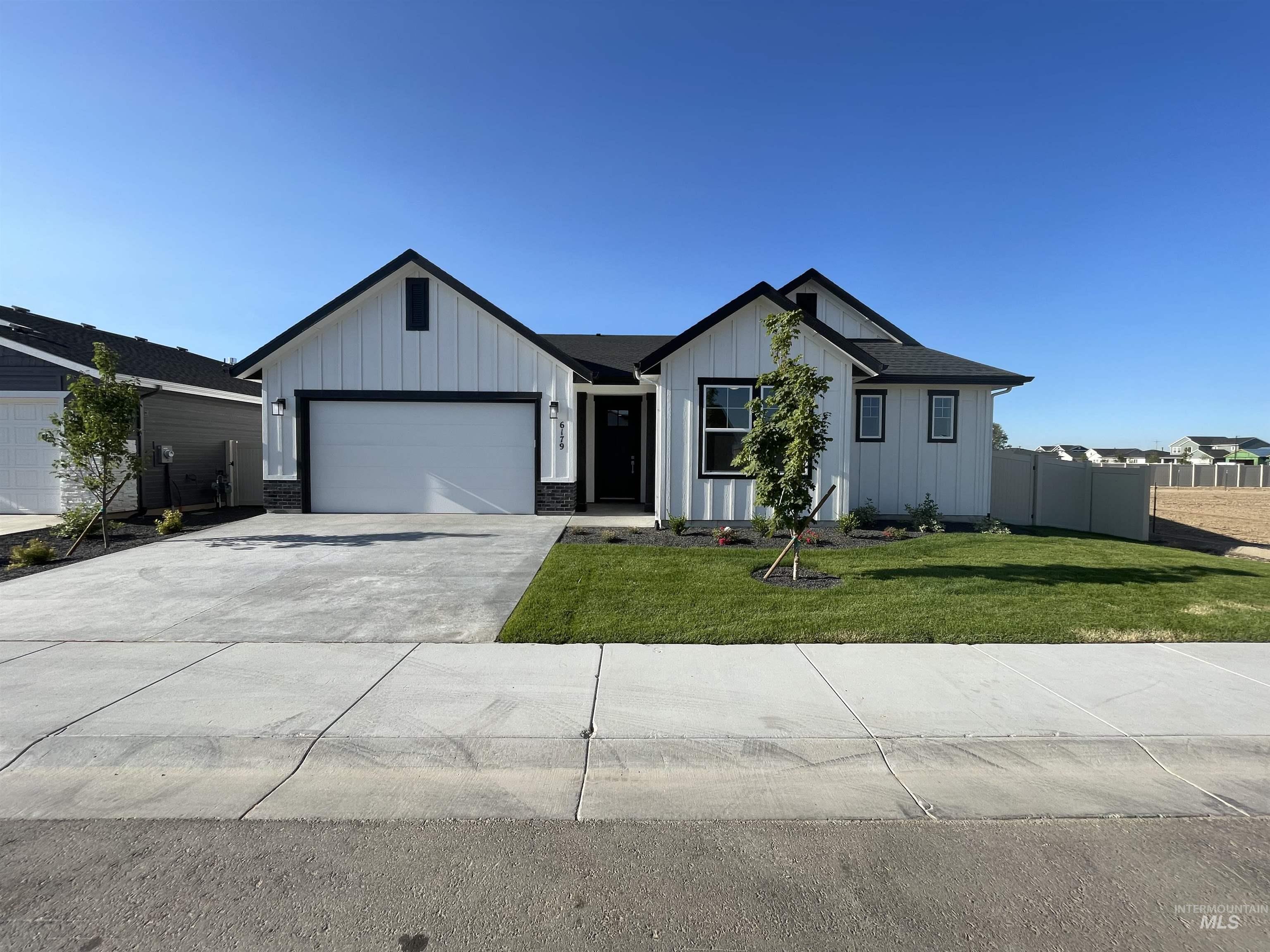 6179 West Ladle Rpds Street Meridian, ID 83646 - Photo 1 of 1 Modern inspired farmhouse featuring an attached garage, board and batten siding, and driveway