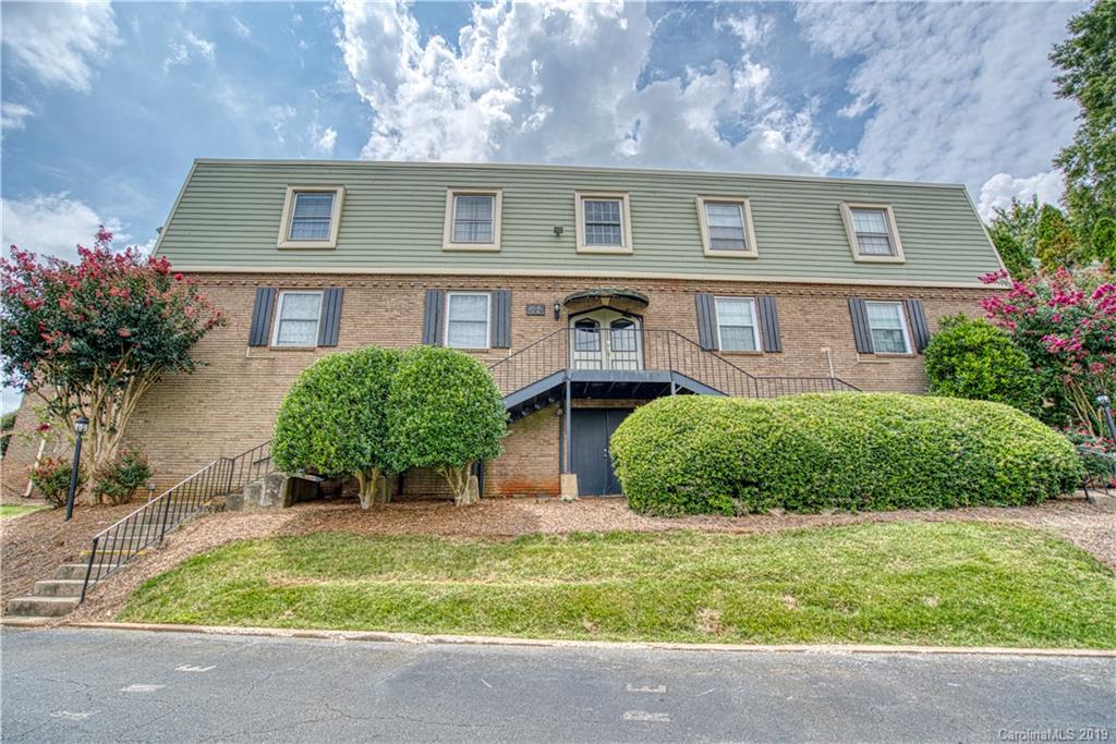 2616 Park Road, Unit H Charlotte, NC 28209 - Photo 1 of 28 a front view of a house with garden