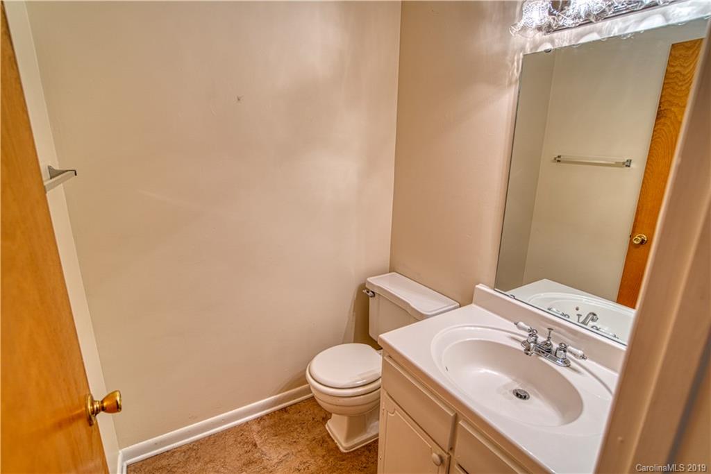2616 Park Road, Unit H Charlotte, NC 28209 - Photo 11 of 28 a bathroom with a sink a toilet and a mirror