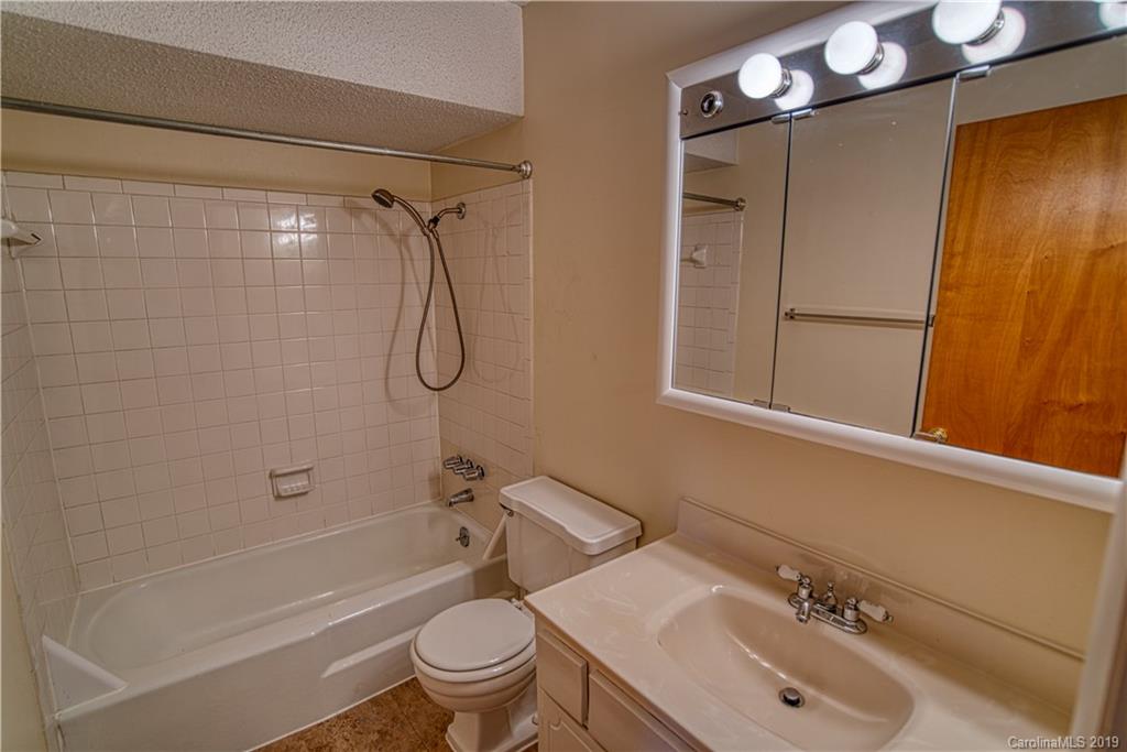 2616 Park Road, Unit H Charlotte, NC 28209 - Photo 14 of 28 a bathroom with a sink toilet and shower