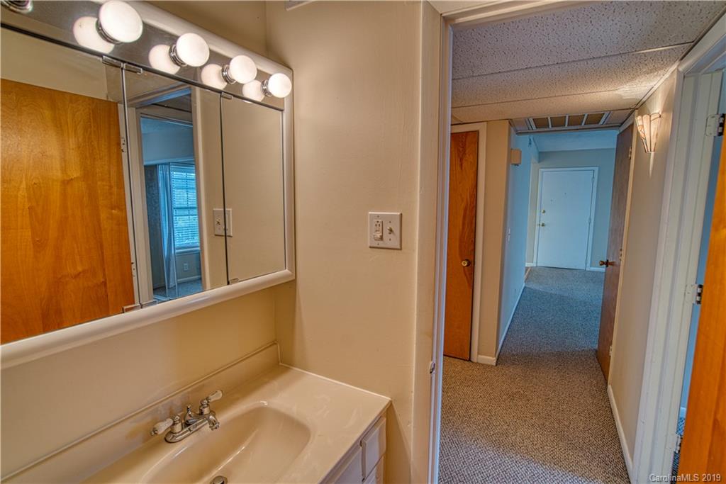 2616 Park Road, Unit H Charlotte, NC 28209 - Photo 15 of 28 a bathroom with a sink and mirror