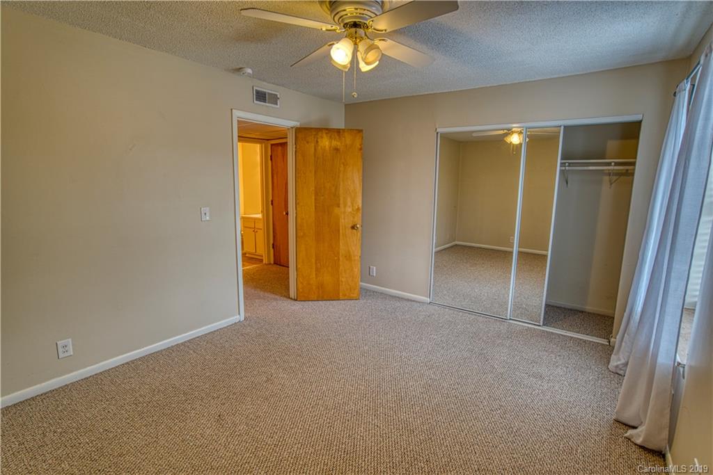 2616 Park Road, Unit H Charlotte, NC 28209 - Photo 24 of 28 an empty room with closet and a chandelier fan