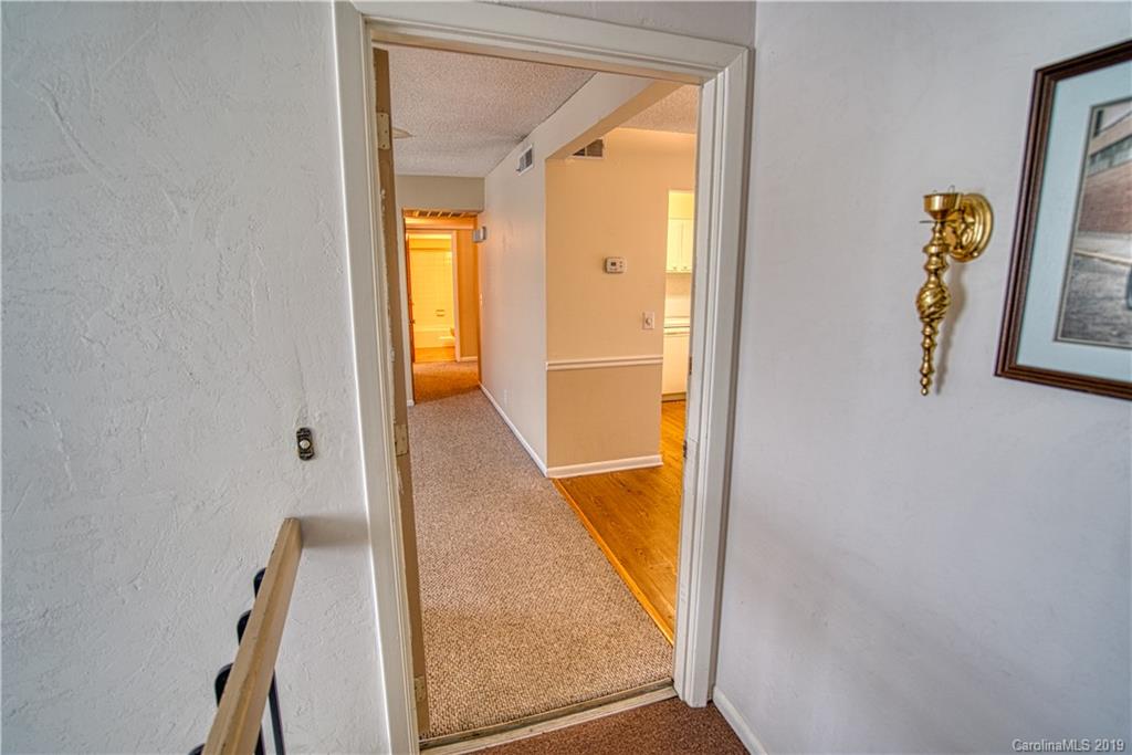 2616 Park Road, Unit H Charlotte, NC 28209 - Photo 4 of 28 a view of a hallway with painted walls and a window