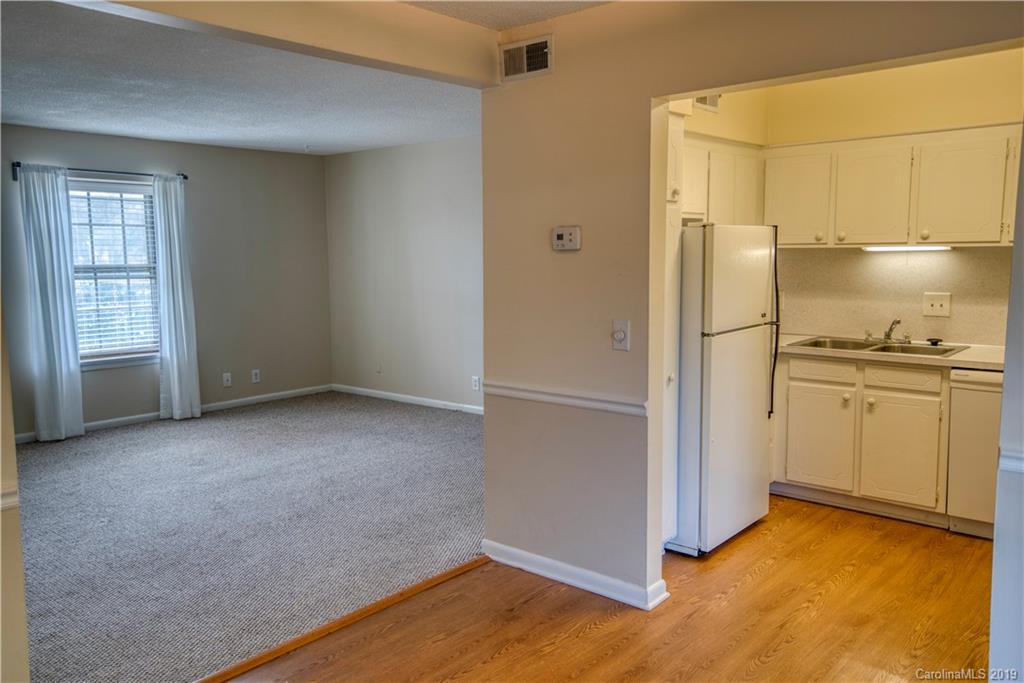 2616 Park Road, Unit H Charlotte, NC 28209 - Photo 6 of 28 a view of empty room with wooden floor and cabinet