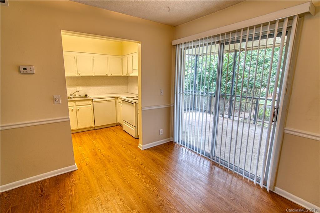 2616 Park Road, Unit H Charlotte, NC 28209 - Photo 7 of 28 a view of a kitchen with wooden floor and a sink