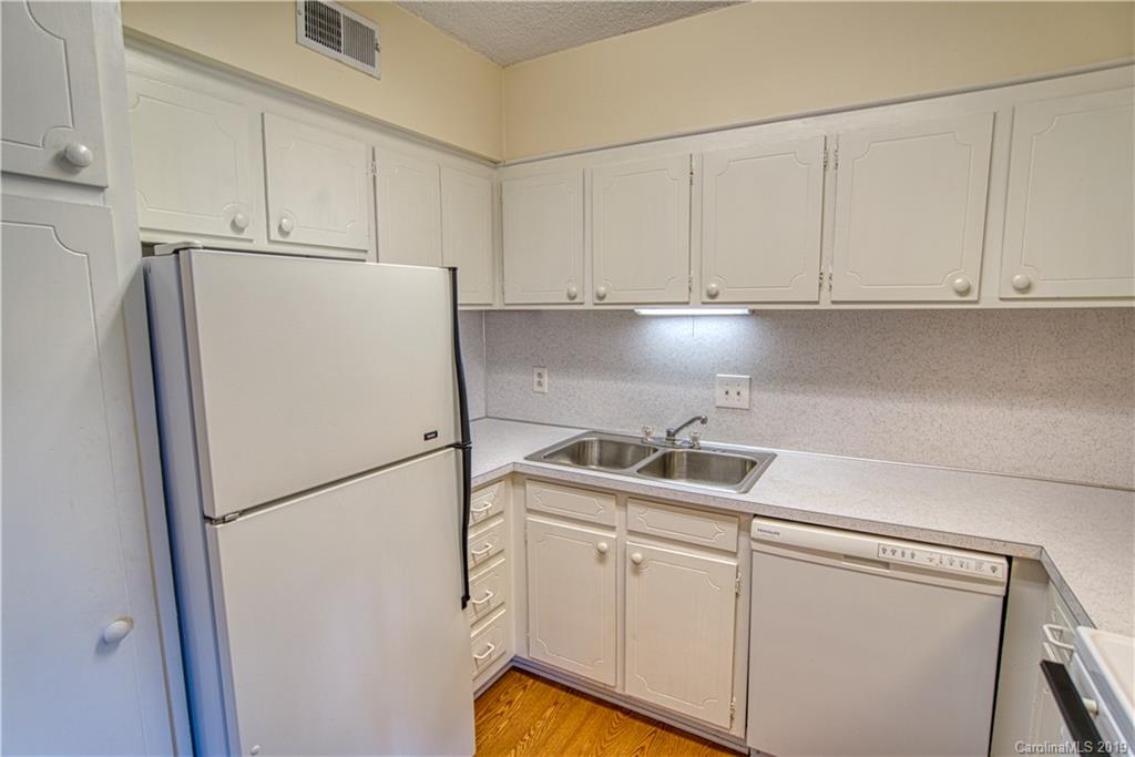 2616 Park Road, Unit H Charlotte, NC 28209 - Photo 10 of 28 a kitchen with appliances a refrigerator and a sink
