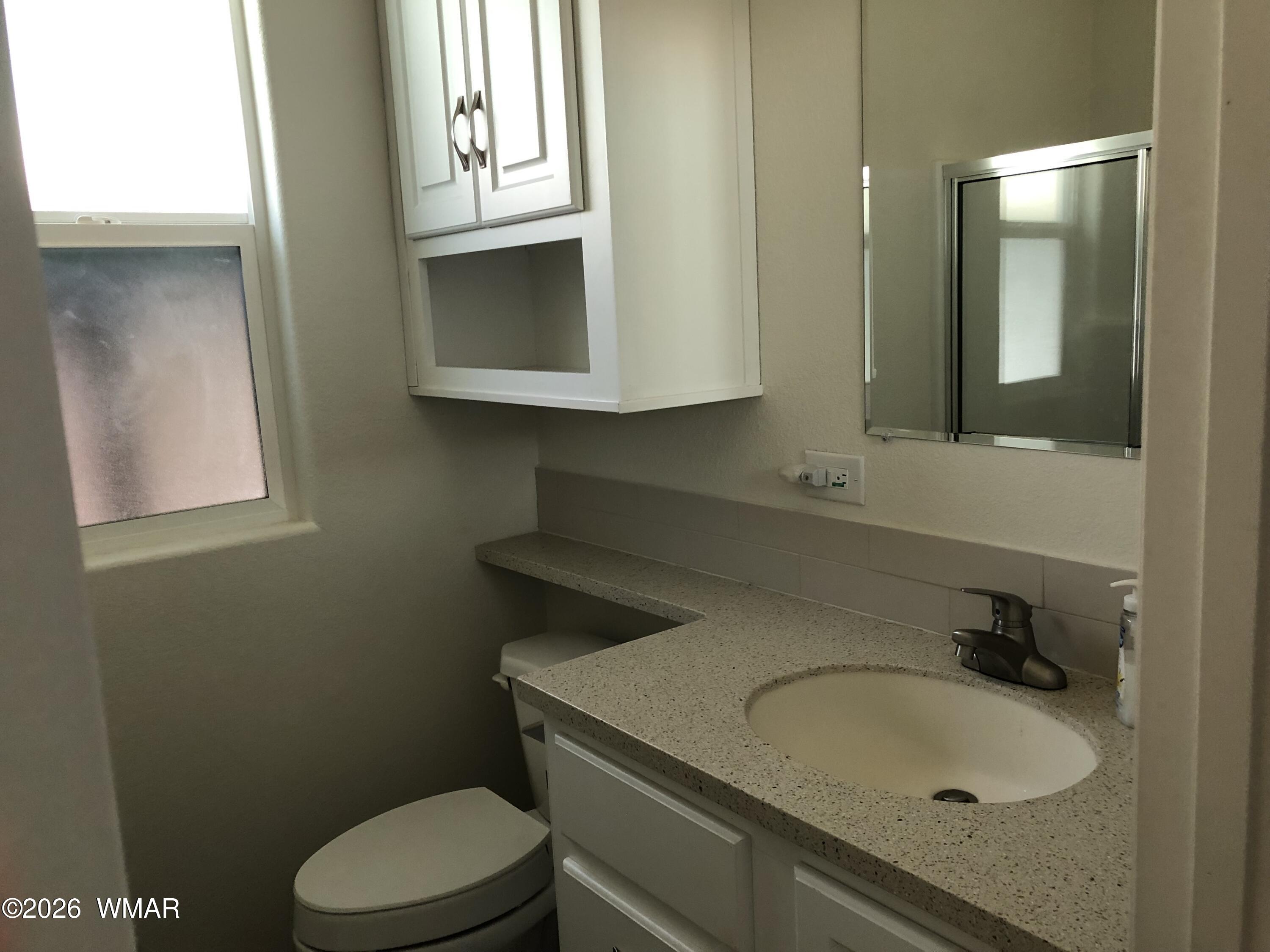 2301 Turtle Creek Road Show Low, AZ 85901 - Photo 18 of 35 a bathroom with a sink toilet and mirror