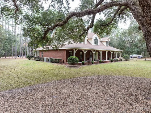 a backyard of a house with table and chairs
