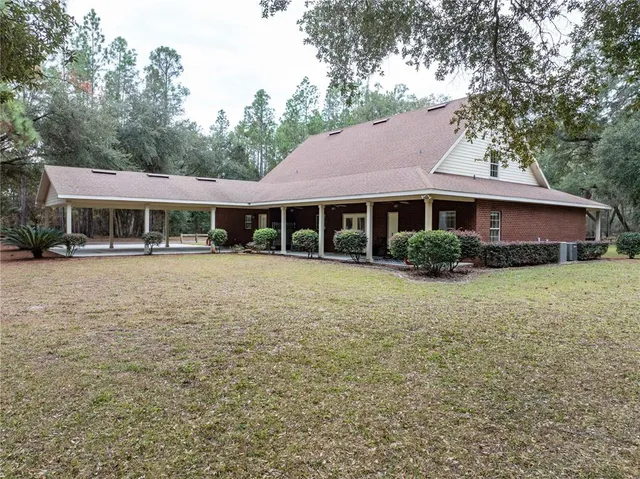 a living room with furniture a chandelier and a rug