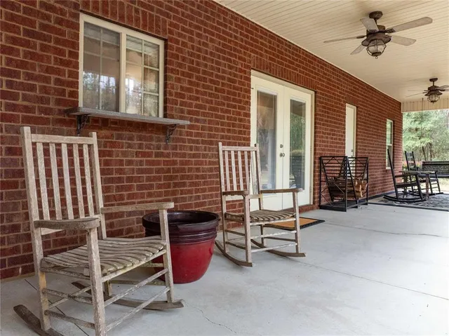 an aerial view of a house with a yard and large trees