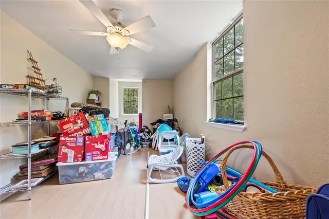 a kitchen with stainless steel appliances kitchen island granite countertop a table chairs in it and a window