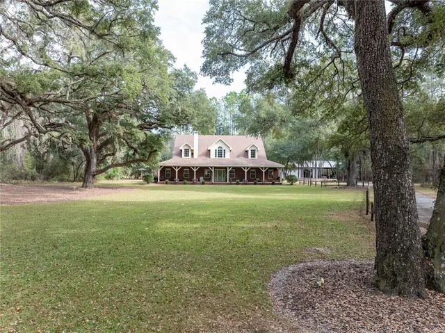 a bathroom with a granite countertop sink a toilet and a mirror