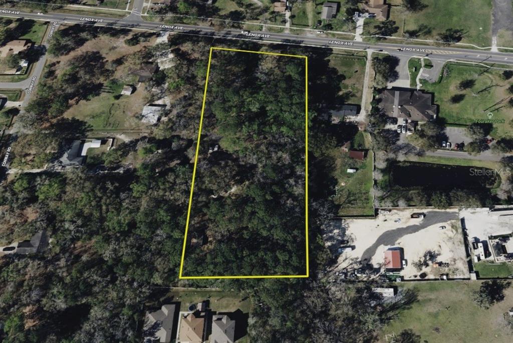 8230 Lenox Avenue Jacksonville, FL 32221 - Photo 30 of 34 an aerial view of a house with a yard and parking spaces