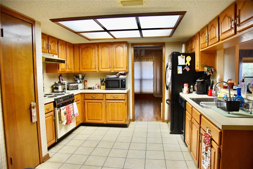 8230 Lenox Avenue Jacksonville, FL 32221 - Photo 9 of 34 a kitchen with stainless steel appliances granite countertop a refrigerator and a sink