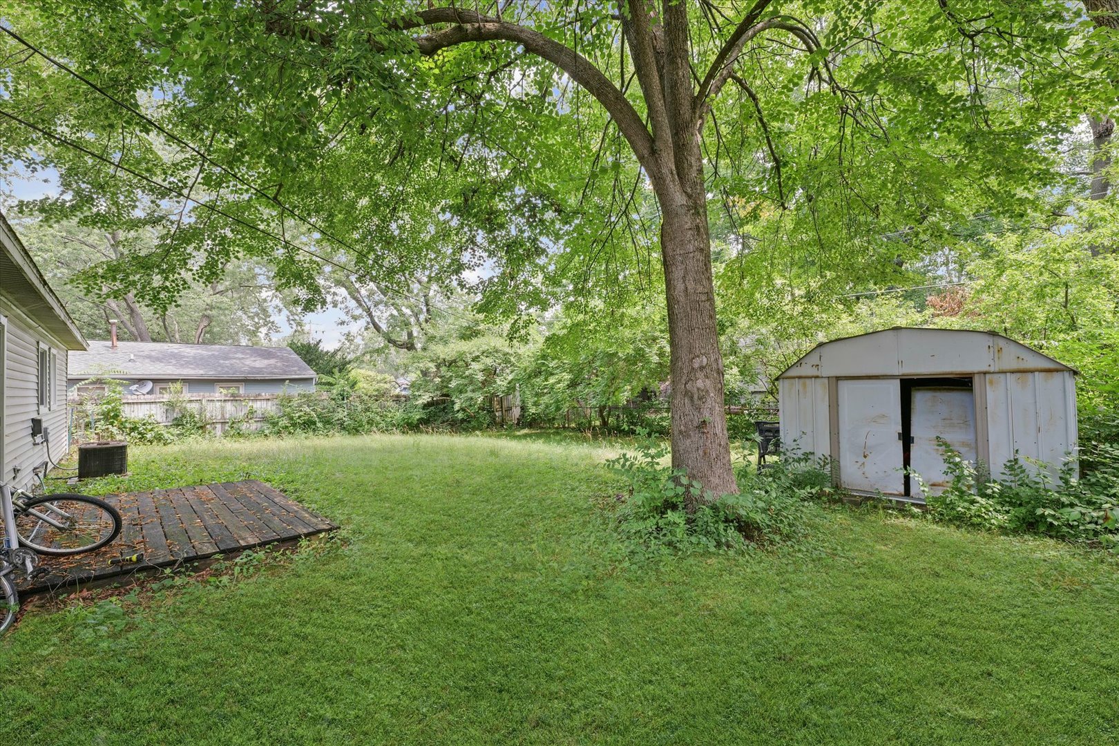 1104 Lanore Drive Urbana, IL 61802 - Photo 11 of 16 a view of a backyard with table and chairs under an umbrella