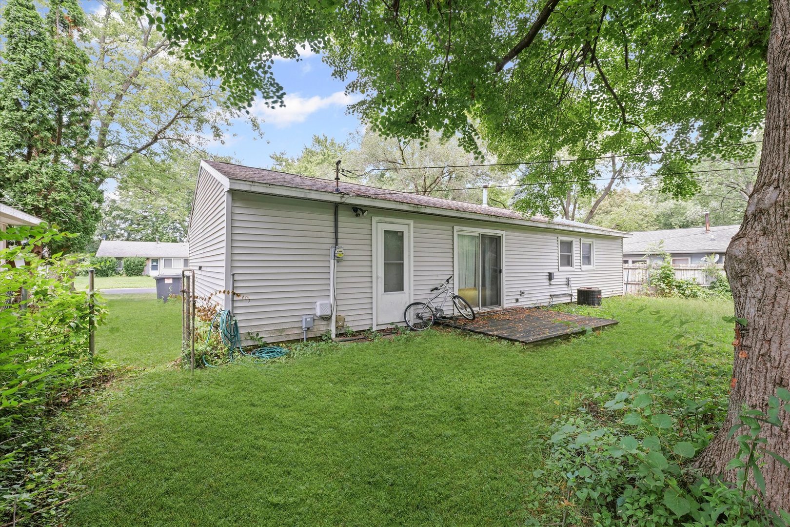 1104 Lanore Drive Urbana, IL 61802 - Photo 12 of 16 a view of a house with backyard sitting area and garden