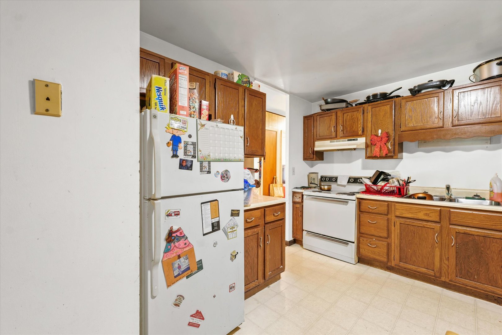 1104 Lanore Drive Urbana, IL 61802 - Photo 8 of 16 a kitchen with a refrigerator and a sink