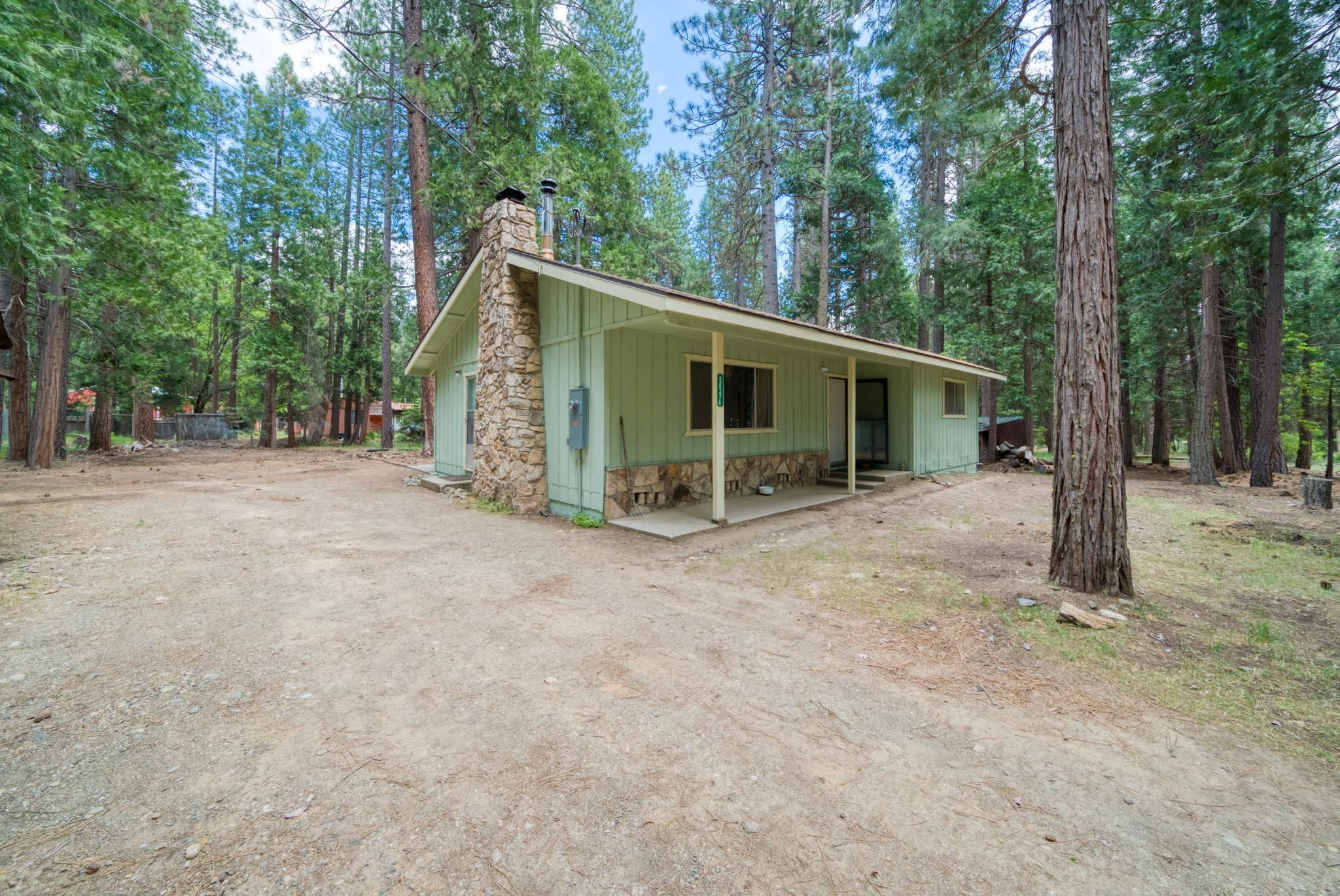 58374 Gill Ranch Road Cromberg, CA 96103 - Photo 5 of 44 a view of a house with a backyard and trees