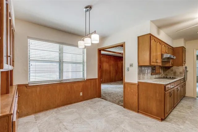 a view of a kitchen with a sink and dishwasher cabinet