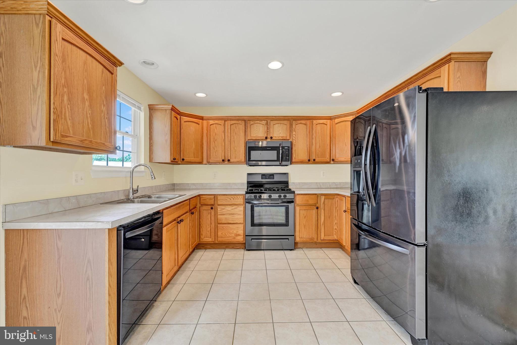 21 Box Circle Baltimore, MD 21221 - Photo 7 of 23 a kitchen with stainless steel appliances granite countertop a refrigerator and a stove top oven
