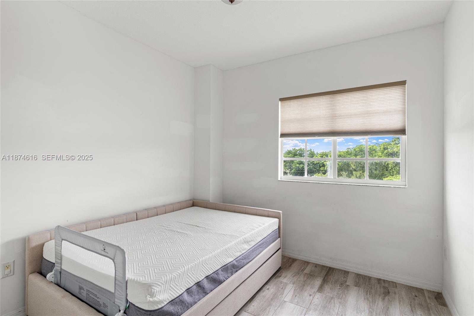 5271 Southwest 8th Street, Unit 315 Miami, FL 33134 - Photo 11 of 26 a bedroom with a bed and a window