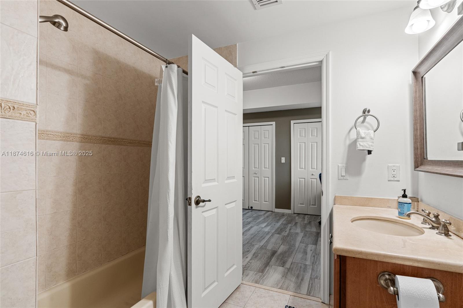 5271 Southwest 8th Street, Unit 315 Miami, FL 33134 - Photo 13 of 26 a bathroom with a sink and a mirror