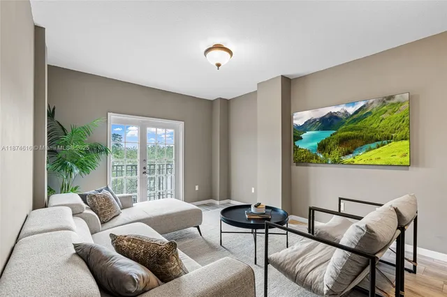 a living room with furniture and a large window