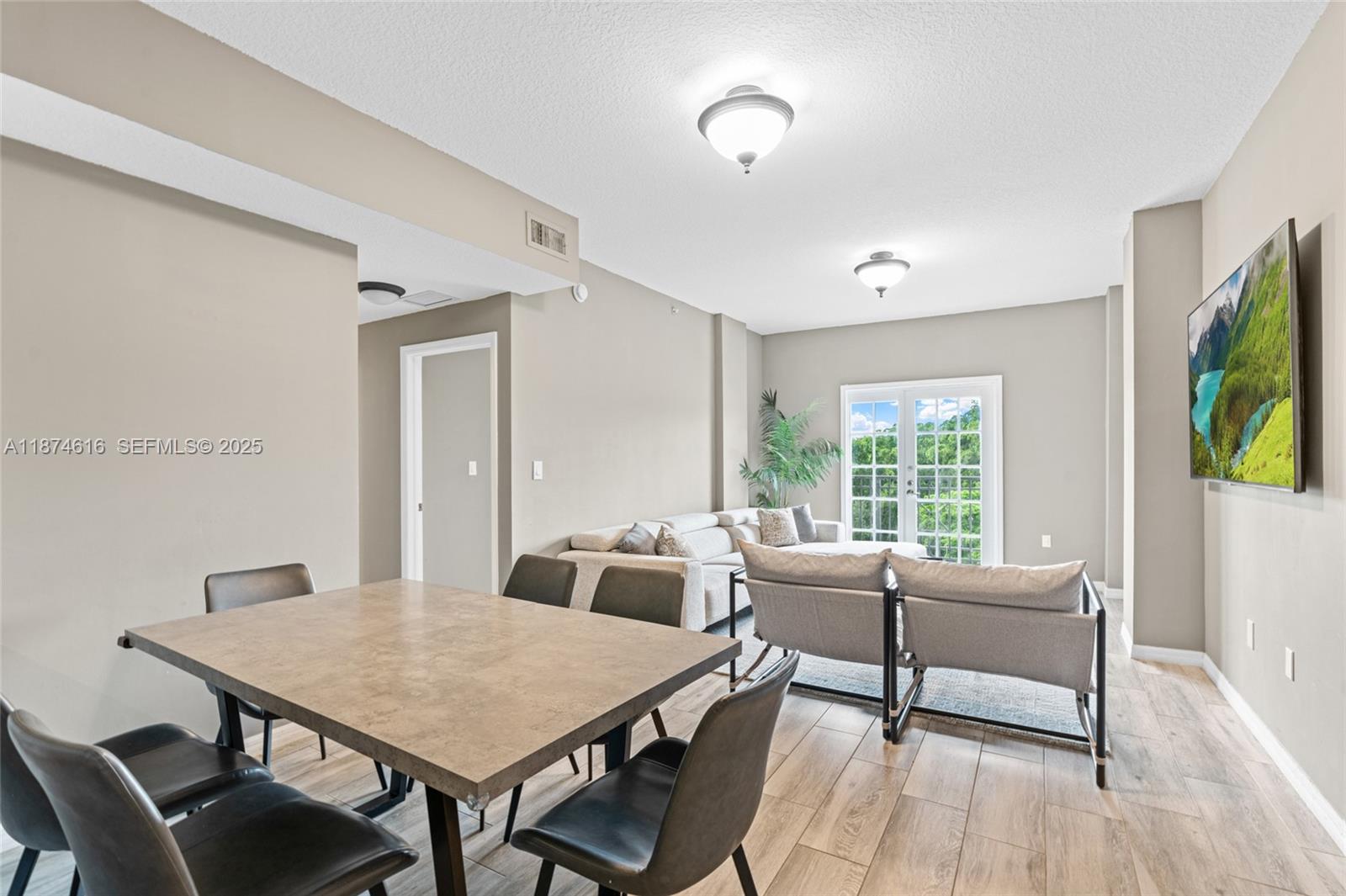 5271 Southwest 8th Street, Unit 315 Miami, FL 33134 - Photo 4 of 26 a view of a dining room with furniture window and wooden floor