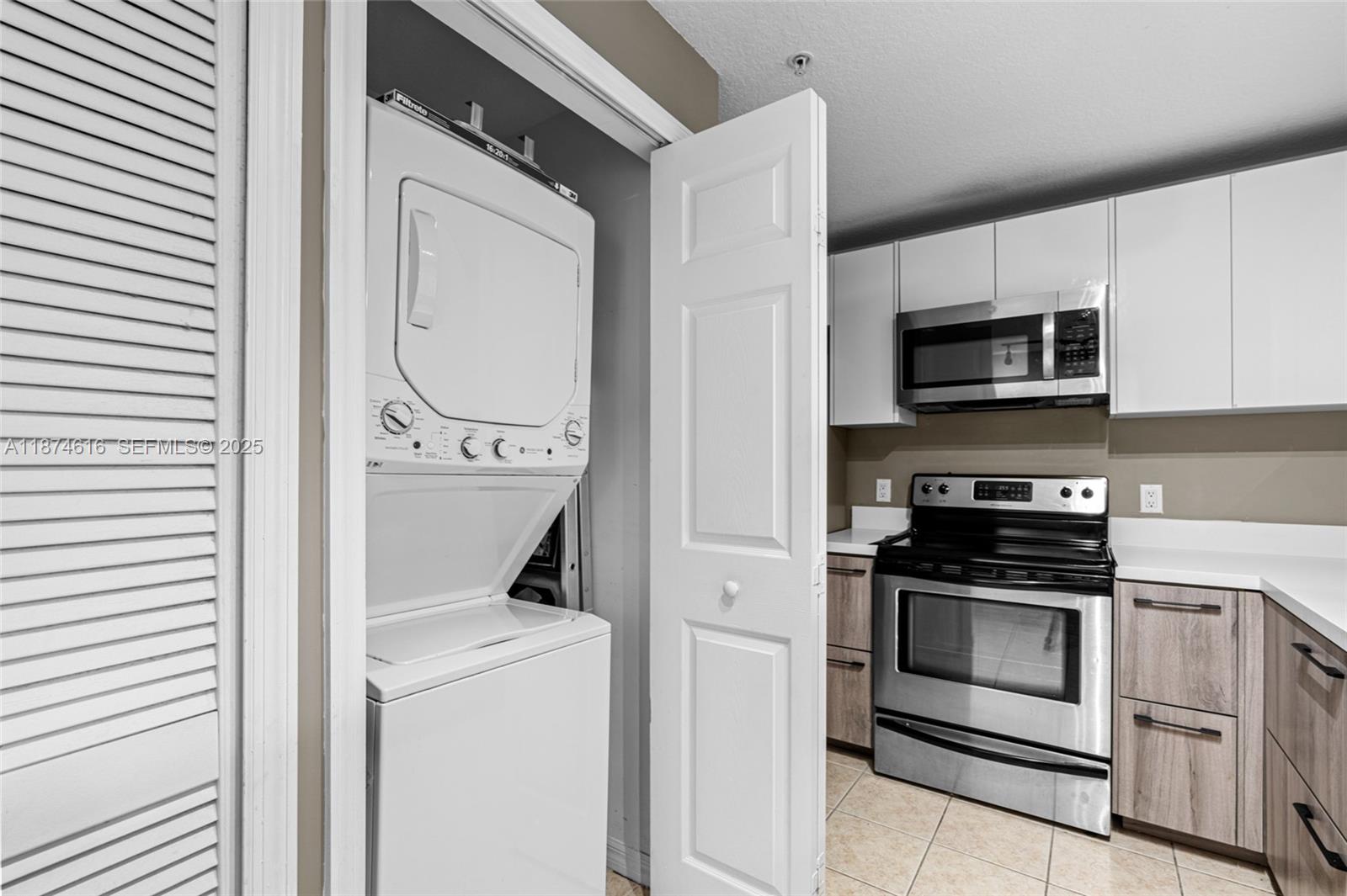 5271 Southwest 8th Street, Unit 315 Miami, FL 33134 - Photo 8 of 26 a kitchen with a stove and a microwave