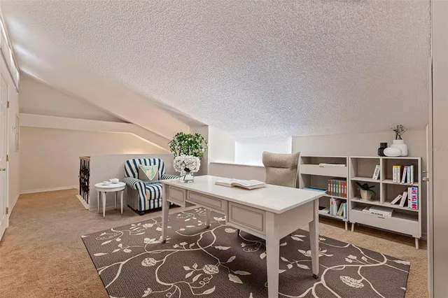 a bedroom with a bed a chandelier and dresser