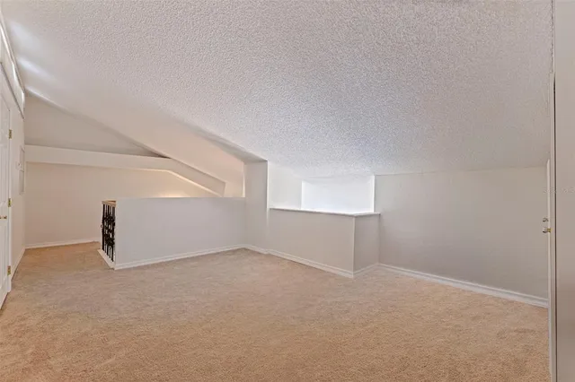 a bathroom with a granite countertop sink toilet and mirror
