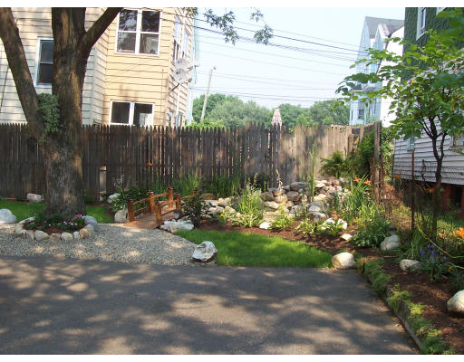 44 Allen Street Springfield, MA 01108 - Photo 4 of 6 a backyard of a house with lots of green space and plants