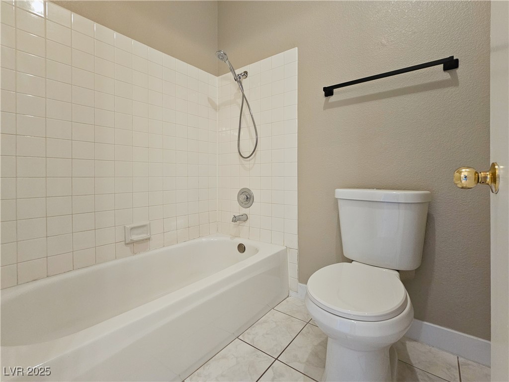 1851 Hillpointe Road, Unit 2124 Henderson, NV 89074 - Photo 19 of 24 Full bathroom with toilet, baseboards, tile patterned floors, and tub / shower combination