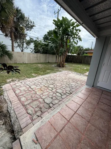 a view of a house with a yard and sitting area
