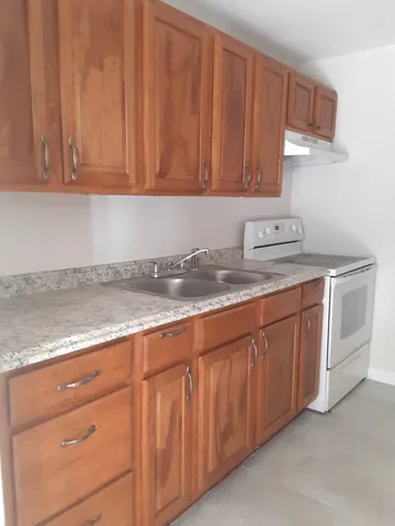a kitchen with a sink stove and cabinets