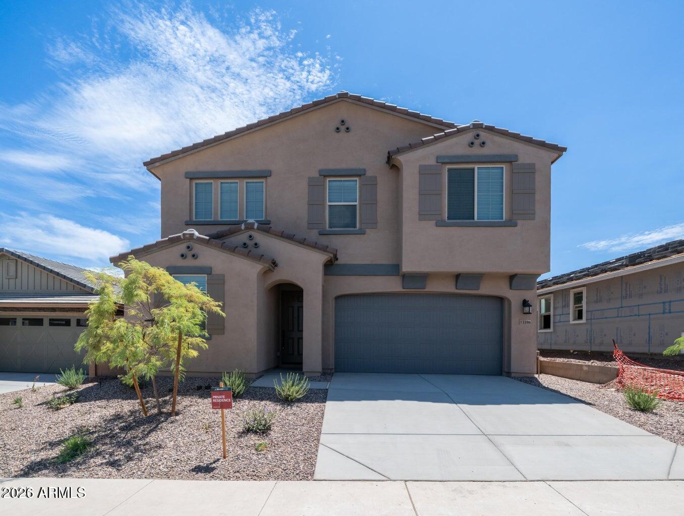 13359 West Eagle Feather Road Peoria, AZ 85383 - Photo 2 of 43 a front view of a house with garden