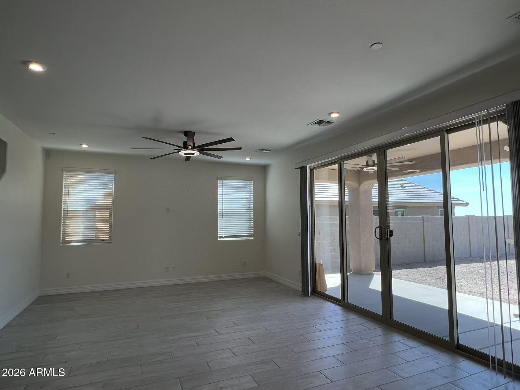 13359 West Eagle Feather Road Peoria, AZ 85383 - Photo 23 of 43 wooden floor in an empty room with a window