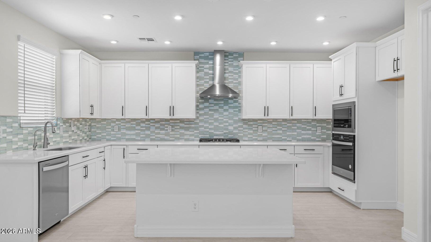 13359 West Eagle Feather Road Peoria, AZ 85383 - Photo 5 of 43 a kitchen with stainless steel appliances granite countertop a stove a sink and a refrigerator