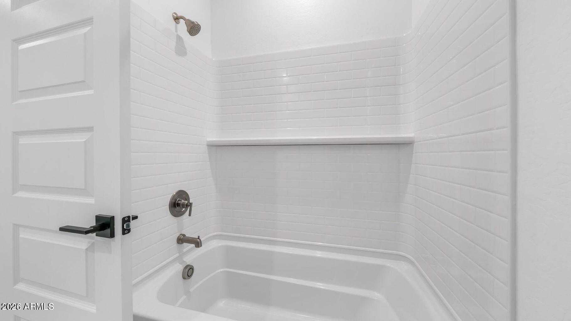 13359 West Eagle Feather Road Peoria, AZ 85383 - Photo 7 of 43 a bathroom with a bathtub