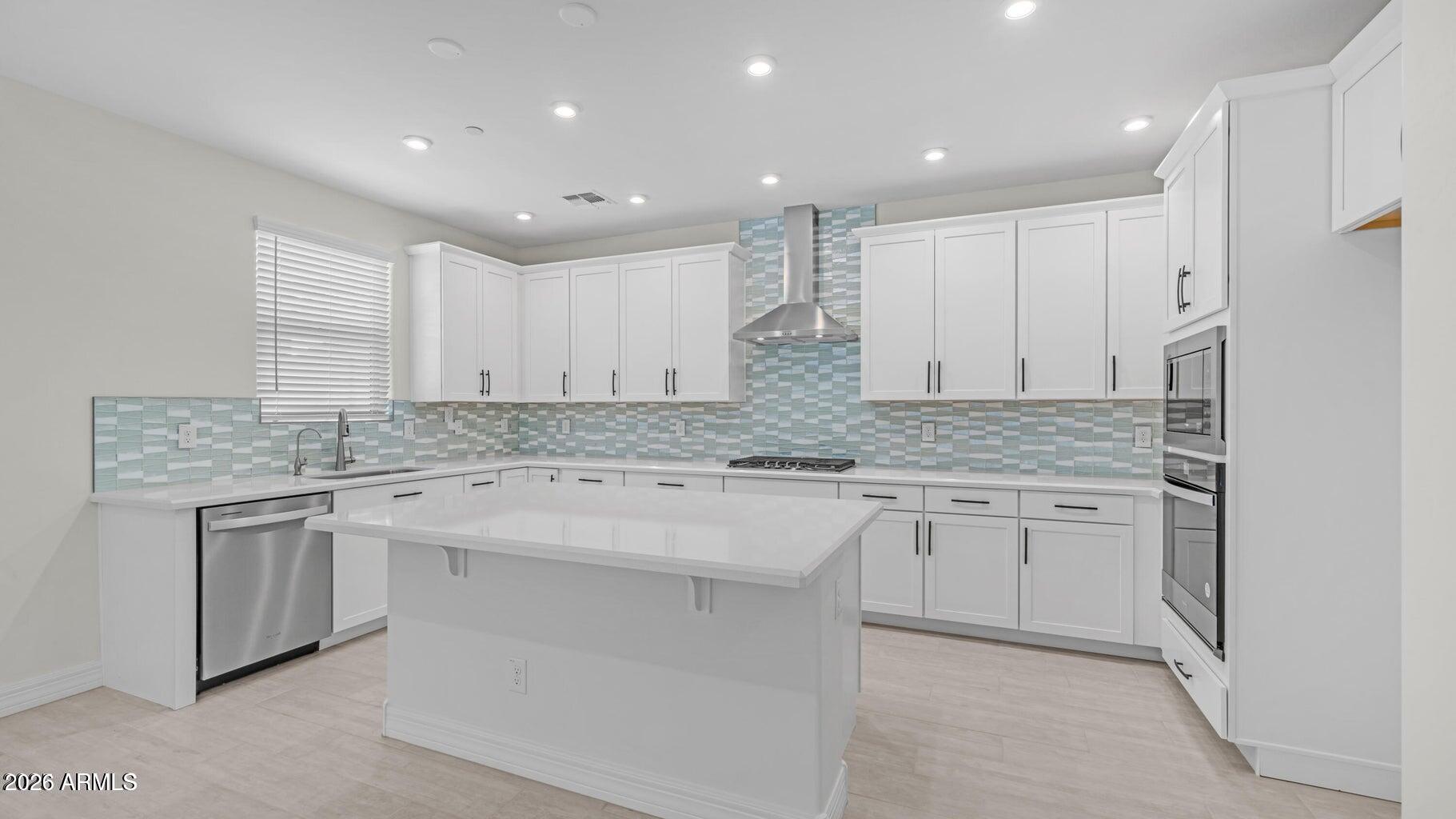 13359 West Eagle Feather Road Peoria, AZ 85383 - Photo 9 of 43 a kitchen with granite countertop cabinets stainless steel appliances and a sink