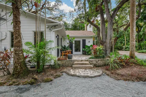 a view of a house with backyard sitting area and garden