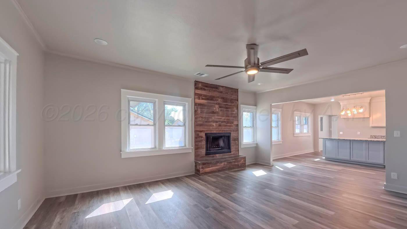 1316 Withers Avenue Amarillo, TX 79108 - Photo 17 of 19 a view of an empty room with wooden floor and a window