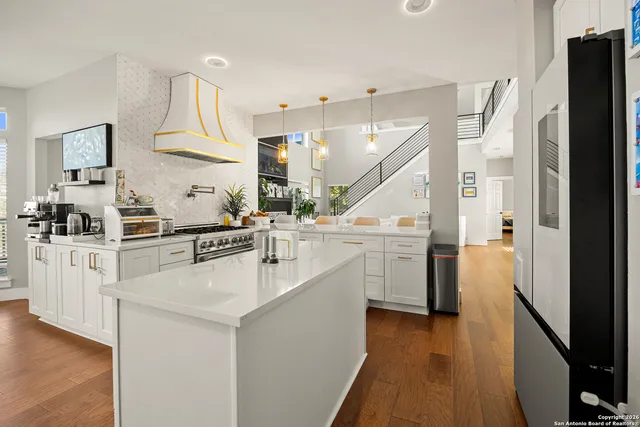 a kitchen with white cabinets and white appliances